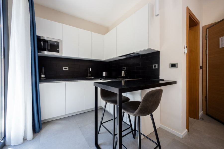 Studio with Forest View kitchen with a breakfast counter and two stools